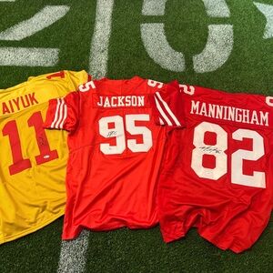 Red and Yellow Football JerseysLot of 3 autographed jerseys.